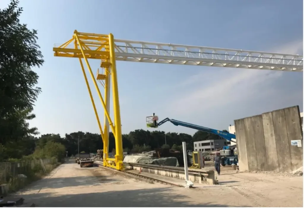 Gele portaalkraan boven een werfterrein